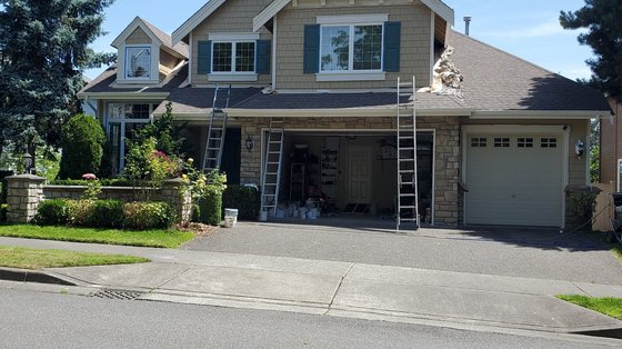 Two-story craftsman with fresh taupe siding and teal shutters