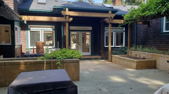 Back patio with deep green trim and new cedar pergola
